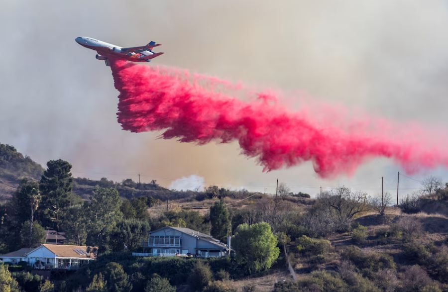 Aerial assault aims to stem LA Palisades fire eastward spread