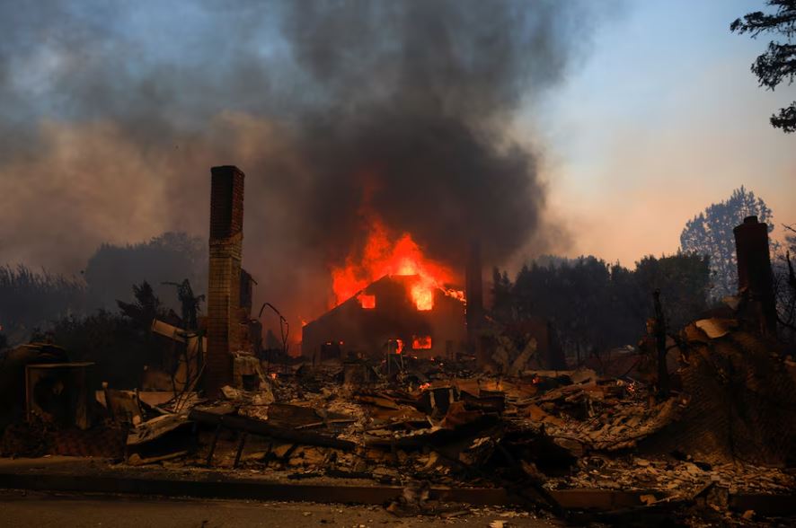 Los Angeles surrounded by out-of-control wildfires; at least five dead